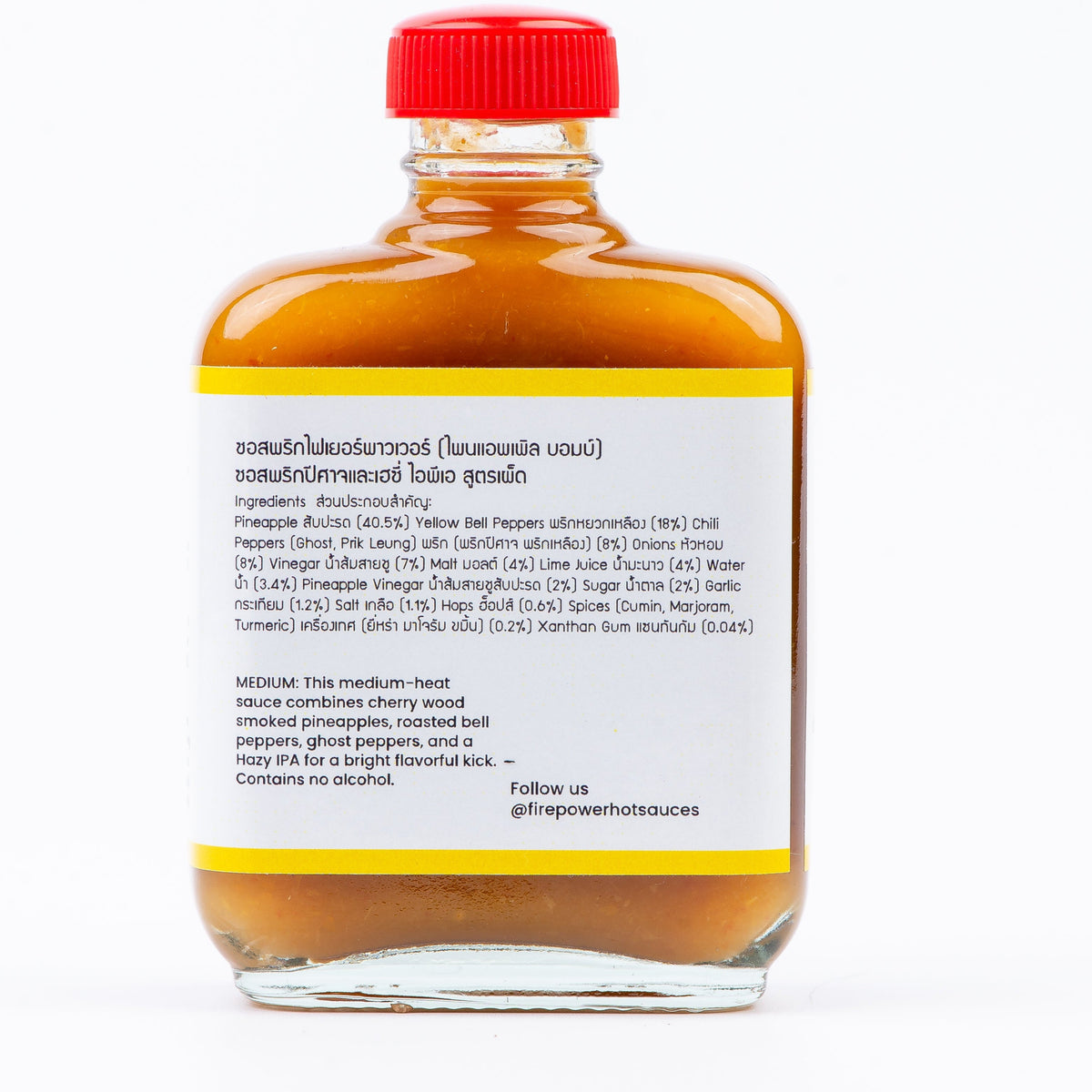 Back of an 85ml bottle of Firepower Pineapple Bomb hot sauce — a smoky-sweet pineapple and ghost pepper sauce made in Bangkok.