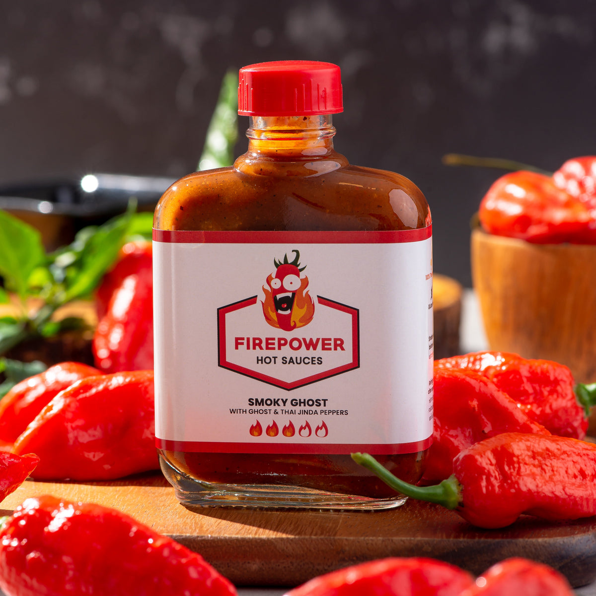 An 85ml bottle of Firepower Smoky Ghost Level 3 hot sauce — our best-selling smoky ghost pepper sauce for BBQ and more, made in Bangkok.
