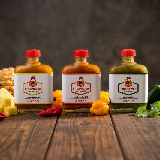 Three 85ml bottles of Firepower craft hot sauce — Pineapple Bomb, Tangy Habanero and Venom Verde — a Level 2 variety bundle made in Bangkok.